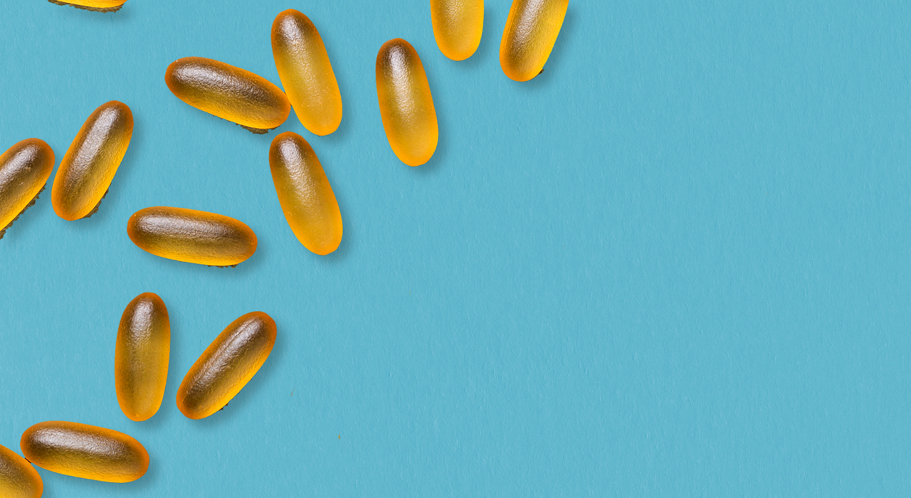 Yellow pill capsules on a blue background