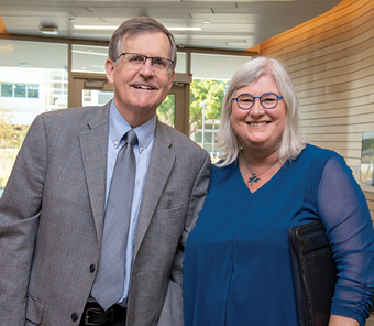 Tom Nesbitt and Heather Young standing side by side in the Betty Irene Moore School of Nursing at UC Davis