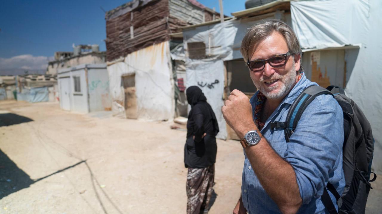Watenpaugh walking through a refugee camp with another person