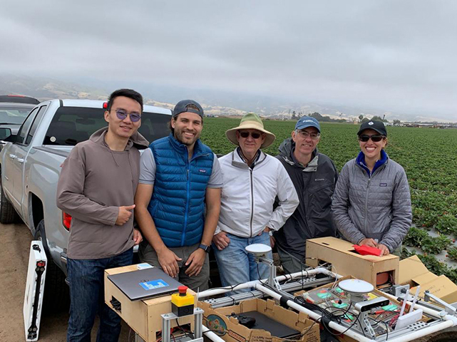 Vougioukas with lab members and the strawberry harvest-aid FRAIL-bot. (Stavros Vougioukas/UC Davis)