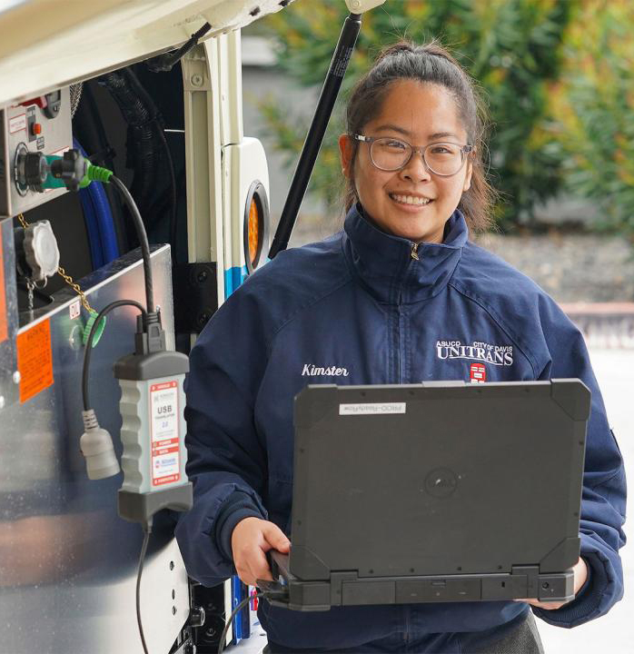 Person with a computer standing outdoors