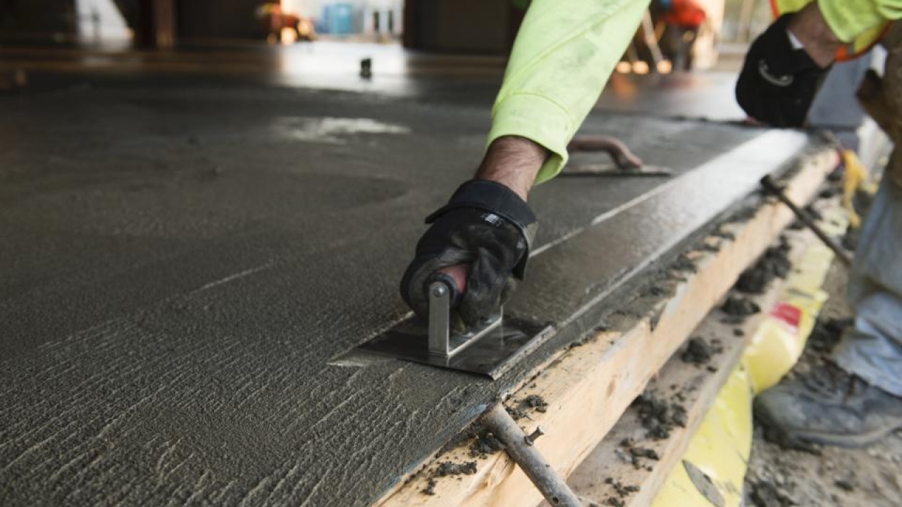 Concrete and cement production are notoriously challenging to decarbonize. A UC Davis study weighs the option for climate and health benefits. (UC Davis) Someone working with concrete