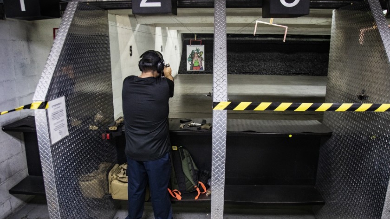 Freddy Torres of Buena Park shoots his gun at the Riverside Indoor Shooting Range in March, after the start of COVID-19 pandemic. (Gina Ferazzi / Los Angeles Times) Freddy Torres of Buena Park shoots his gun at the Riverside Indoor Shooting Range