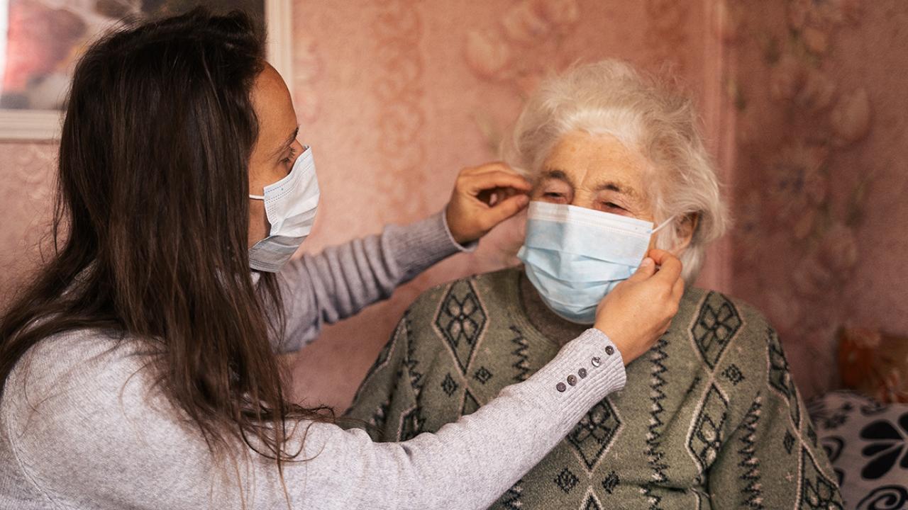 It’s as crucial for family caregivers to take care of themselves as their relatives. Two people wearing masks