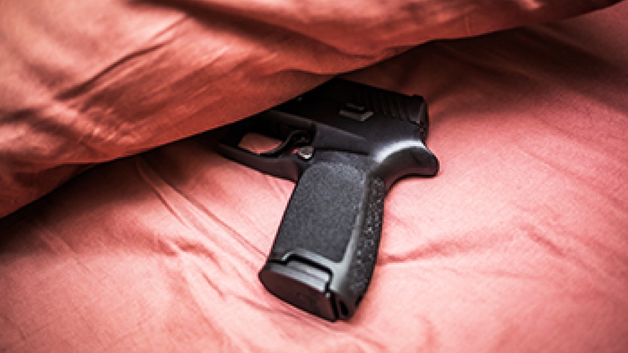 Owning a gun or living in a house with a gun linked to a lower perception of risk for gun violence. Gun under pillow