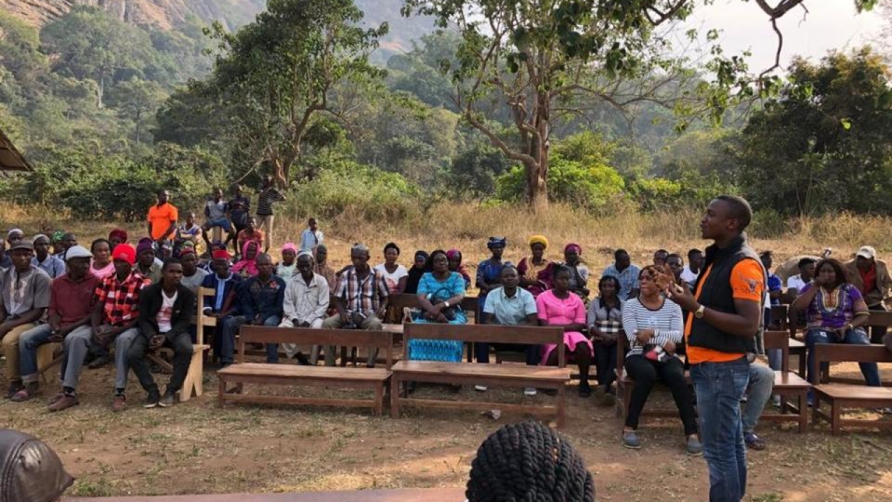 A community engagement meeting about Marburg virus in Kakoya village, Sierra Leone. Following discovery of Marburg virus in bats in three districts of Sierra Leone, the PREDICT-USAID team worked with the Sierra Leone government to inform people about his new health risk. (Yongai Bona/PREDICT) Kakoya village meeting