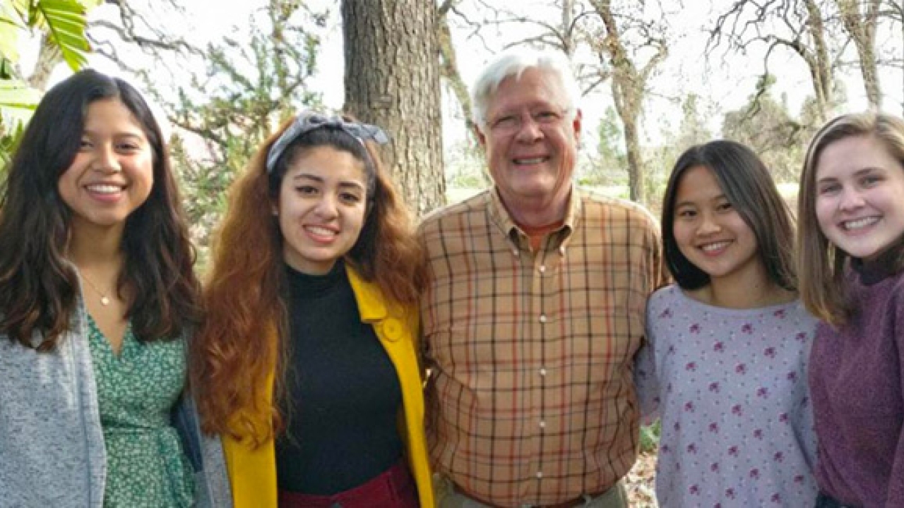 Five people standing outdoors