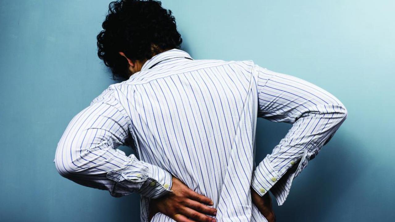 Man experiencing back pain 