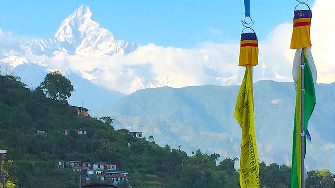 A Seminar Abroad with travel to Nepal over winter break is part of a project to expand student opportunities for global experiences. Nepalese flags with moutains in the background