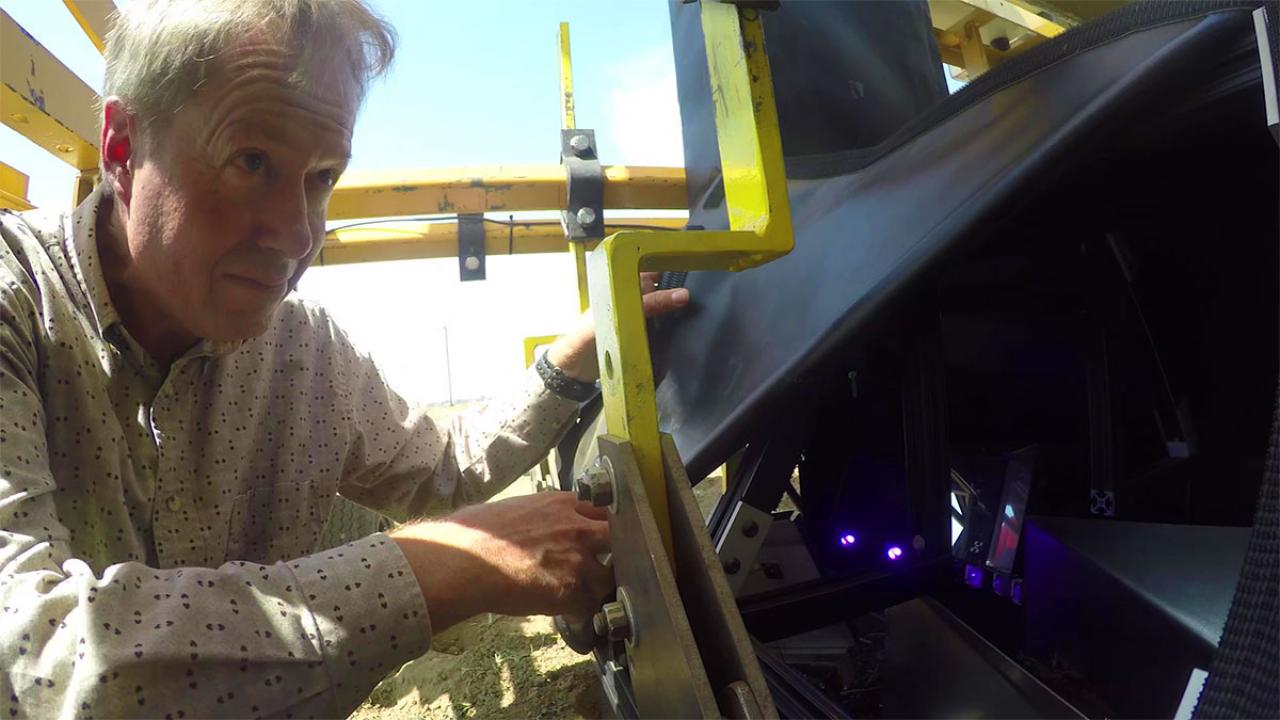 Professor David Slaughter calibrates a smart farm robot