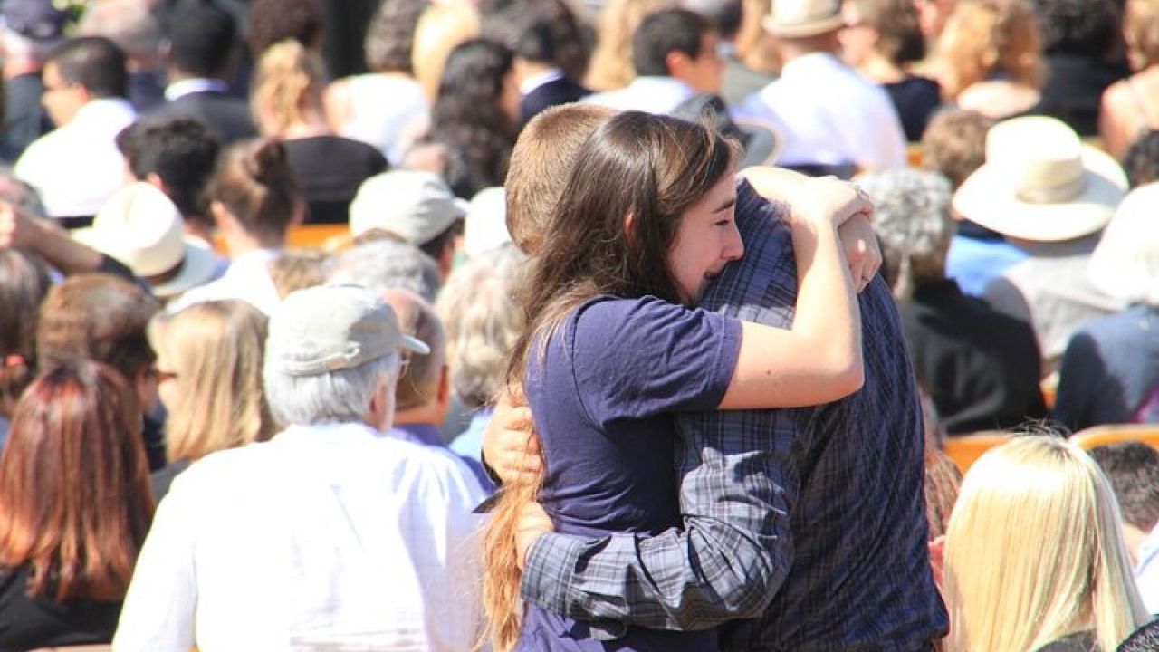 Patricia Marroquin - Moment Editorial/Getty Images People hugging in a crowd