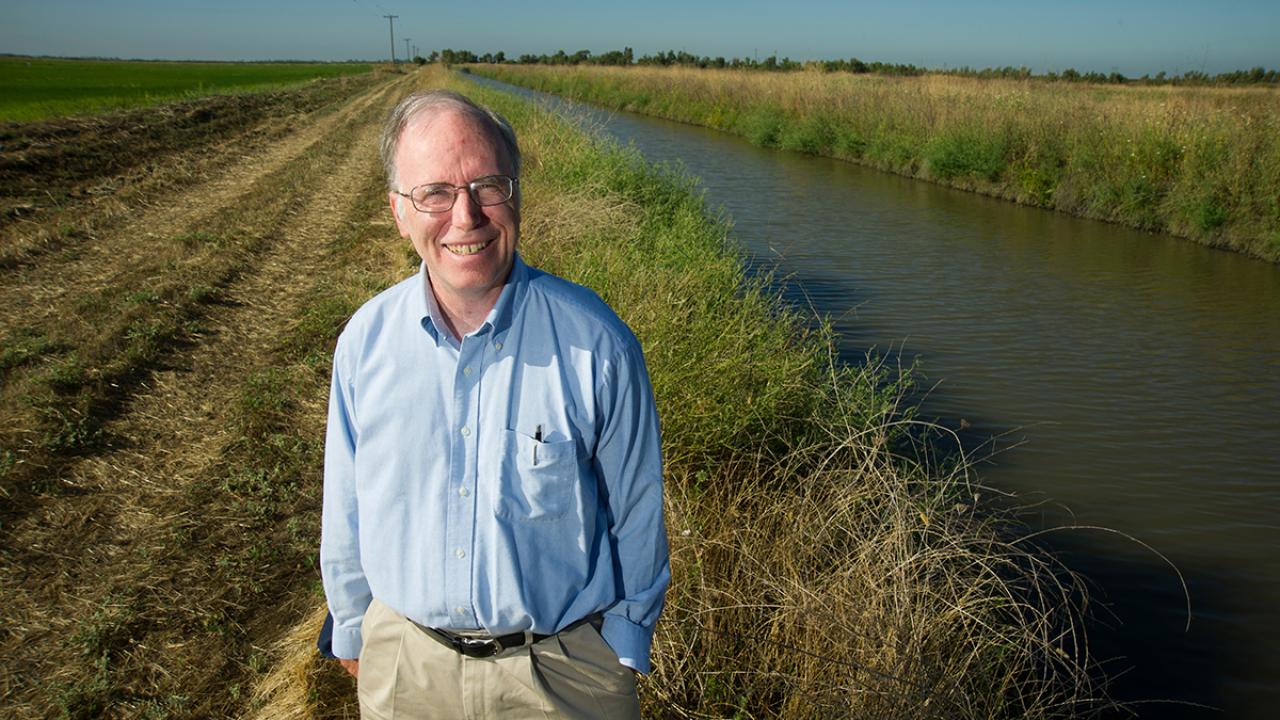 Jay Lund standing in front of a water canal
