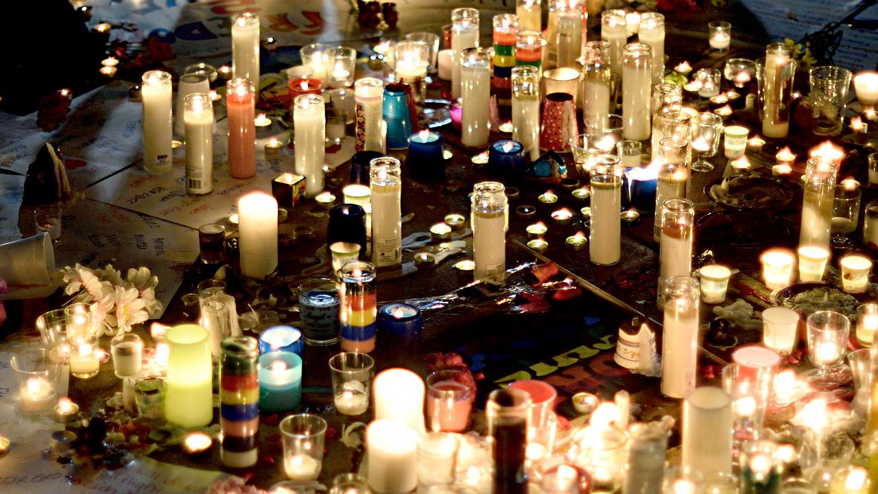 Candlelight vigil image highlights and remembers the victims of violence. 