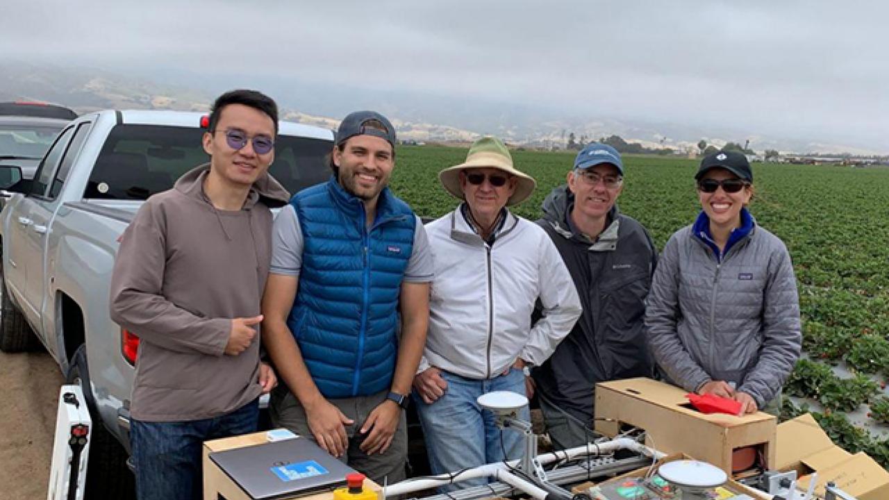 Vougioukas with lab members and the strawberry harvest-aid FRAIL-bot. (Stavros Vougioukas/UC Davis)