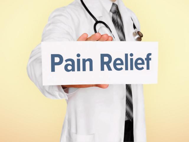 Doctor holding a sign that says 'pain relief'