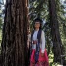 Maria Arteaga standing in front of a redwood tree
