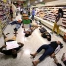 Demonstrators against gun violence lying on the floor of a supermarket in Orlando, Fla., last year.