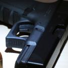 Close up image of a handgun and bullet