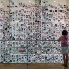 Person in front of wall of photos