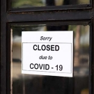 Sign on window reading "Sorry closed due to COVID-19"